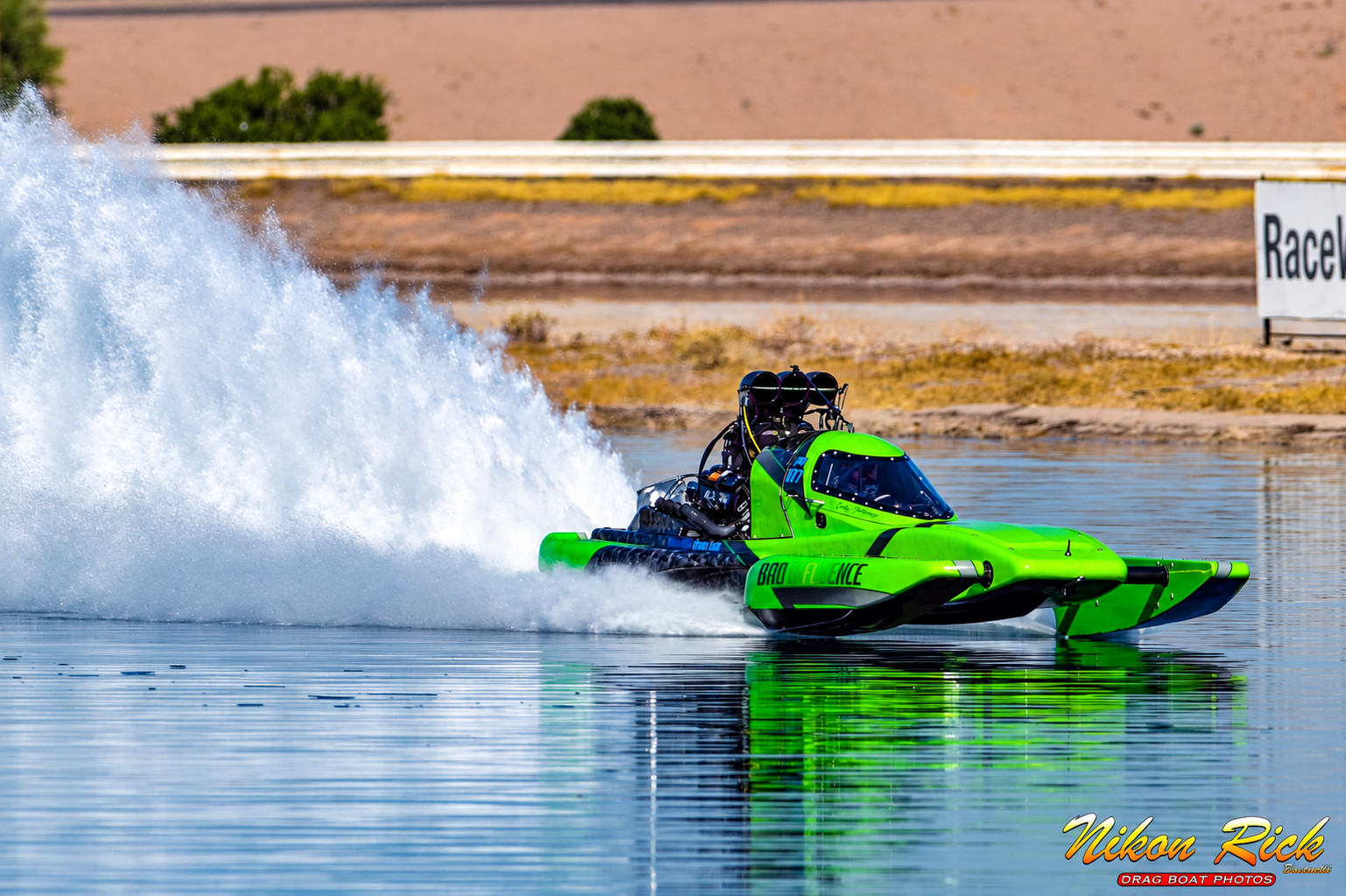 Green drag boat accelerating across the water, photographed by Nikon Rick